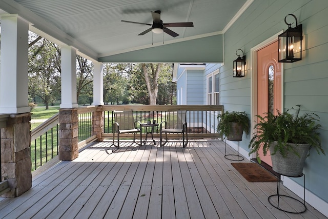 wooden terrace featuring ceiling fan and covered porch