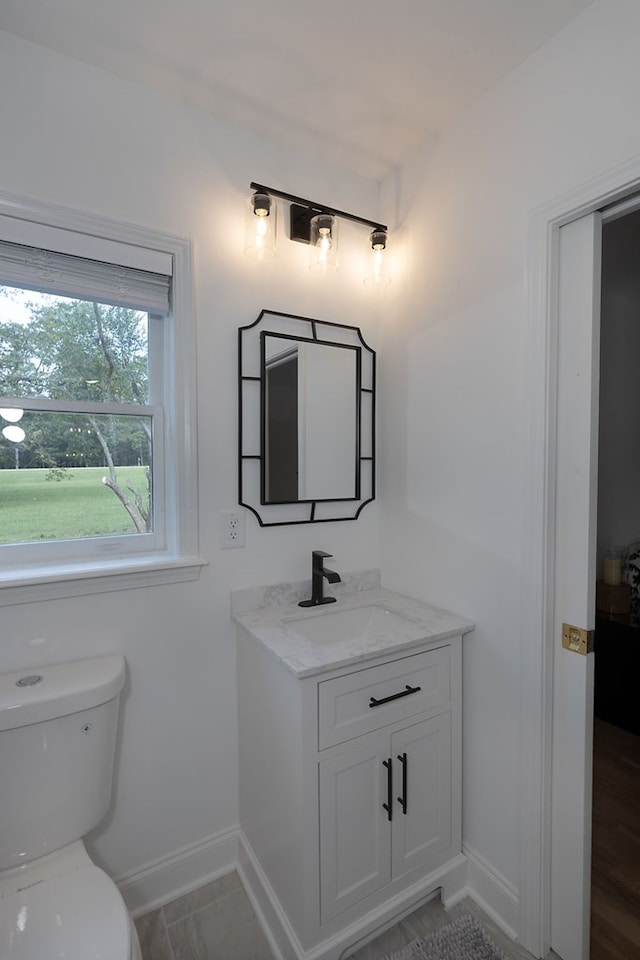 bathroom featuring vanity and toilet