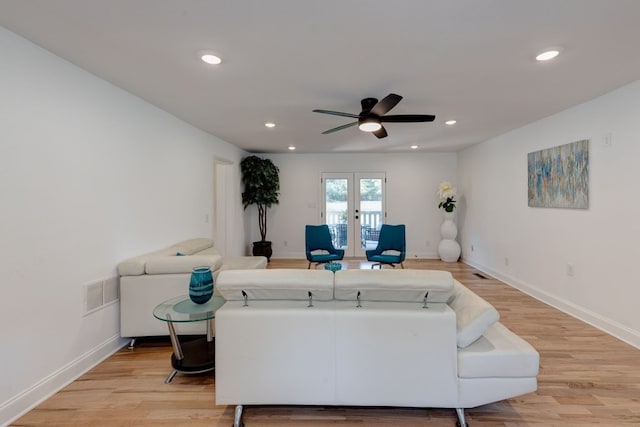 living room with light hardwood / wood-style flooring, french doors, and ceiling fan