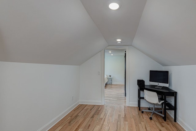 home office featuring vaulted ceiling and light wood-type flooring