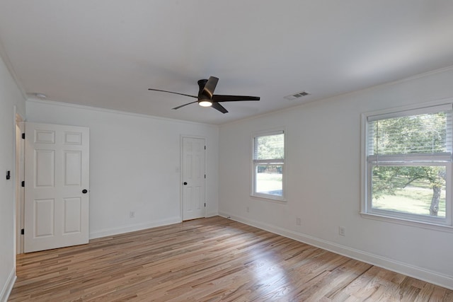 spare room with crown molding, ceiling fan, and light hardwood / wood-style floors