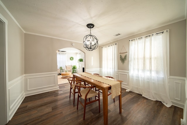 dining room with ornamental molding, dark hardwood / wood-style flooring, and a notable chandelier