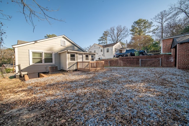 rear view of property featuring central AC unit and a deck