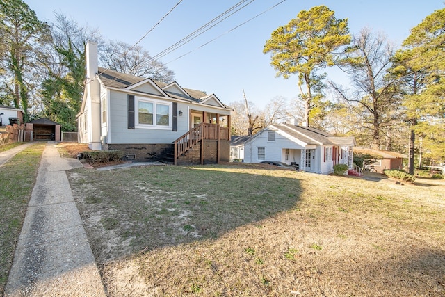 view of front facade featuring an outbuilding, a garage, and a front yard