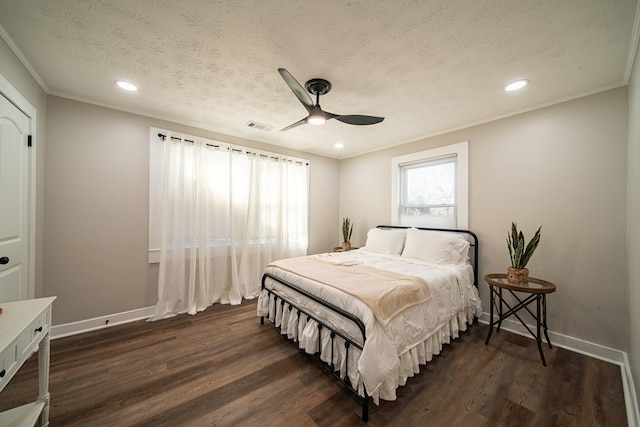 bedroom featuring ceiling fan, dark hardwood / wood-style flooring, and a textured ceiling