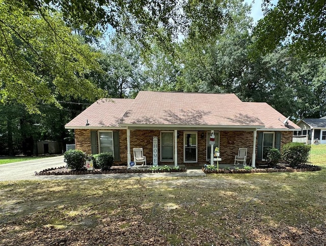 single story home with a front lawn and a porch