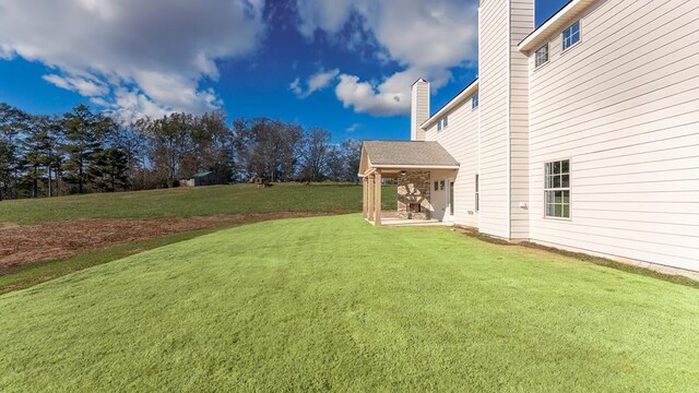 view of patio / terrace with ceiling fan and an outdoor stone fireplace