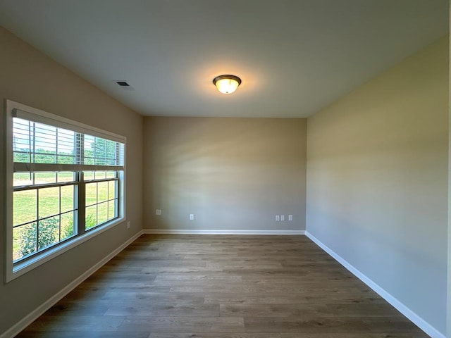 spare room featuring dark wood-type flooring