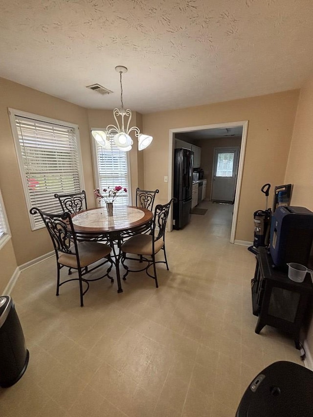 4 Kennedy St, Phenix City, AL 36869 - dining space featuring a chandelier and a textured ceiling