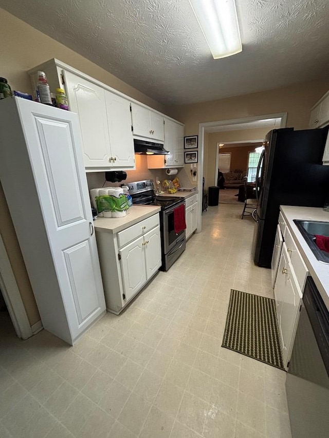 4 Kennedy St, Phenix City, AL 36869 - kitchen with stainless steel appliances, under cabinet range hood, light countertops, white cabinets, and a textured ceiling
