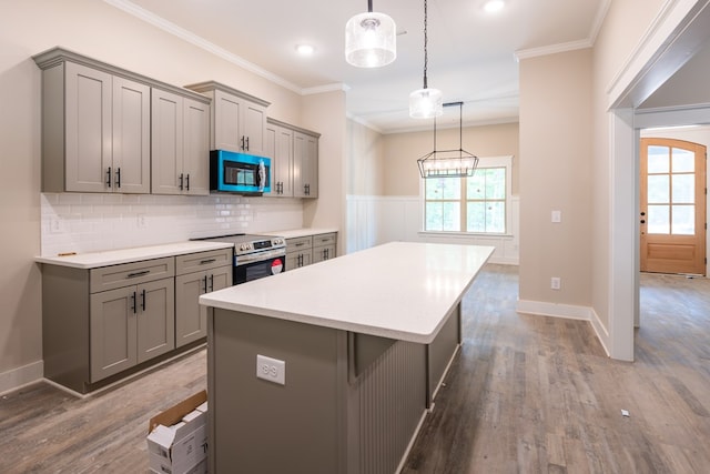 kitchen with gray cabinetry, stainless steel electric range oven, a kitchen island, ornamental molding, and recessed lighting