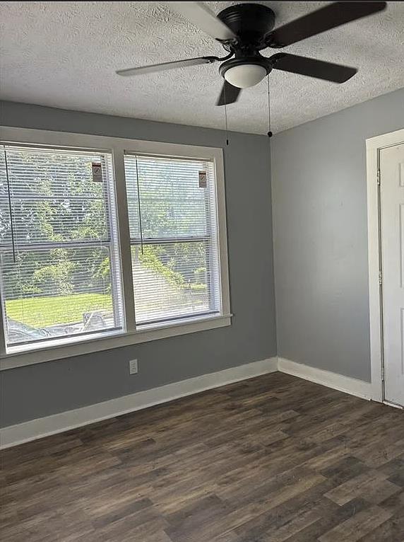 2717 Baldwin St, Columbus, GA 31906 - unfurnished room featuring healthy amount of natural light, dark wood-style floors, a textured ceiling, a ceiling fan, and baseboards
