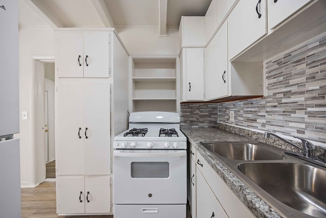 kitchen with white cabinetry, light wood-type flooring, sink, white range with gas cooktop, and decorative backsplash