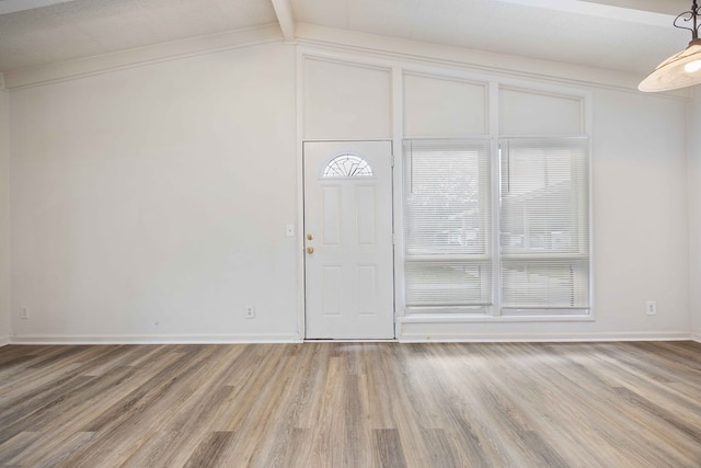 interior space with vaulted ceiling with beams and wood-type flooring