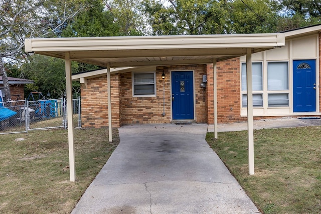 entrance to property with a yard and a carport