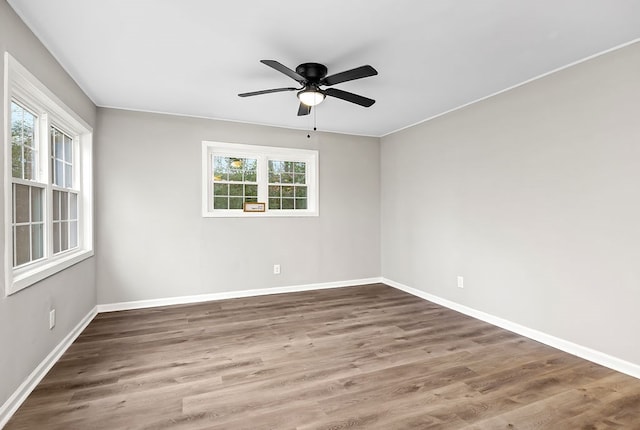 spare room featuring wood finished floors and baseboards