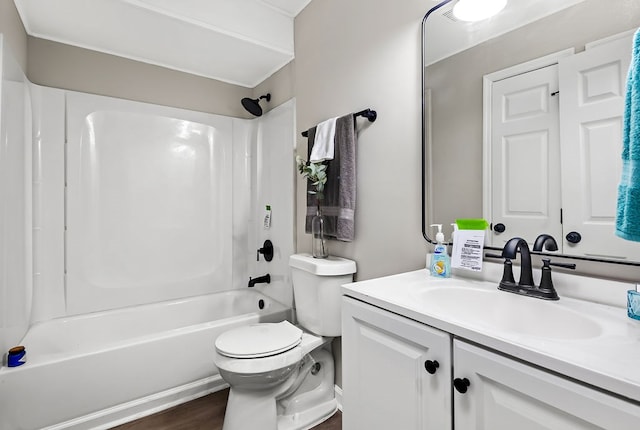 bathroom featuring wood finished floors, toilet,  shower combination, and vanity