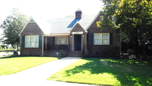 tudor home with a front yard