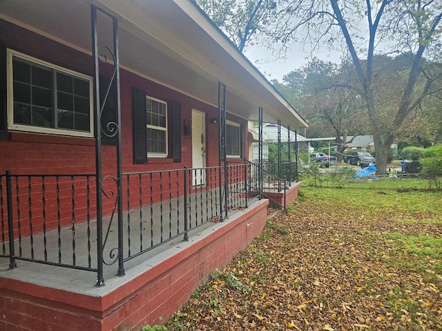 view of side of property with covered porch