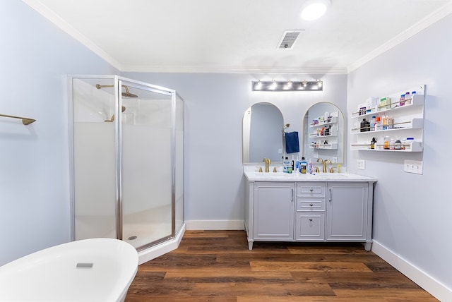 full bath featuring a stall shower, visible vents, ornamental molding, and wood finished floors