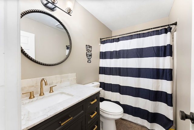 bathroom with a shower with shower curtain, vanity, and toilet