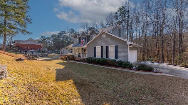 view of front facade with a garage, a front yard, and covered porch