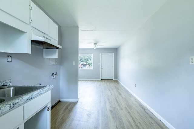 kitchen with white cabinets, extractor fan, light hardwood / wood-style flooring, and ceiling fan