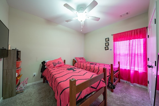 bedroom featuring baseboards, visible vents, ceiling fan, and carpet flooring