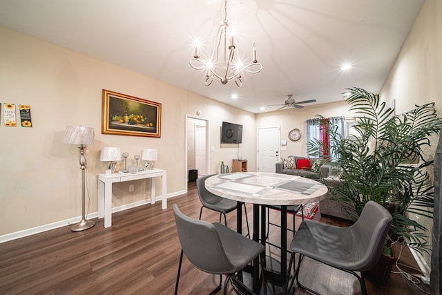 dining area with dark wood-style floors, recessed lighting, baseboards, and ceiling fan with notable chandelier