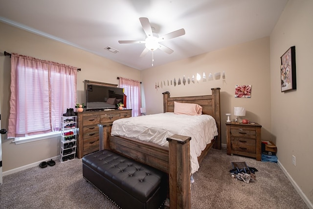 carpeted bedroom with baseboards, visible vents, and a ceiling fan