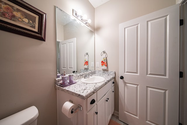 bathroom with toilet and vanity