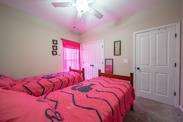 bedroom with carpet floors, a closet, visible vents, and a ceiling fan