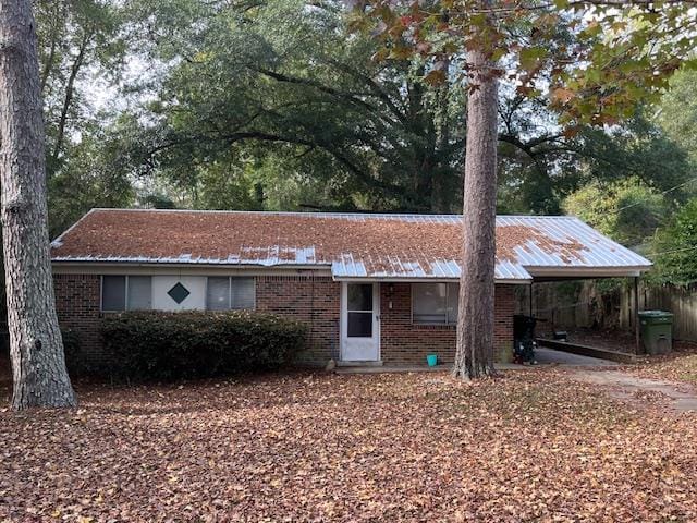 single story home featuring a carport