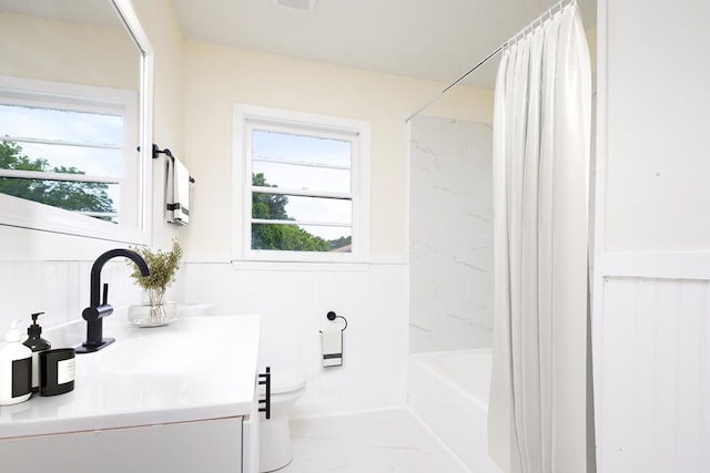 2917 Doyle Ave, Columbus, GA 31907 - bathroom featuring vanity, shower / bath combination with curtain, a wainscoted wall, and marble finish floors