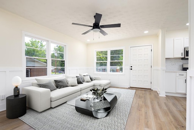 2917 Doyle Ave, Columbus, GA 31907 - living area featuring a wainscoted wall, a decorative wall, light wood finished floors, and ceiling fan