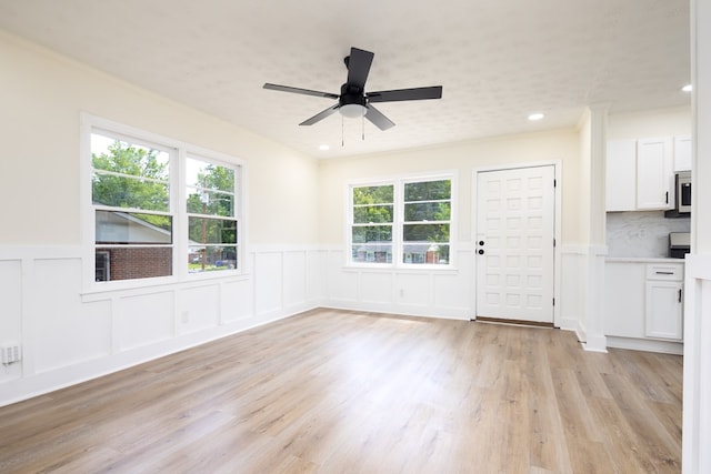 2917 Doyle Ave, Columbus, GA 31907 - unfurnished living room with wainscoting, ceiling fan, light wood-style floors, a decorative wall, and recessed lighting