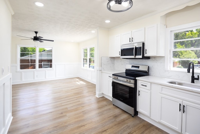 2917 Doyle Ave, Columbus, GA 31907 - kitchen with appliances with stainless steel finishes, a sink, light countertops, white cabinets, and recessed lighting