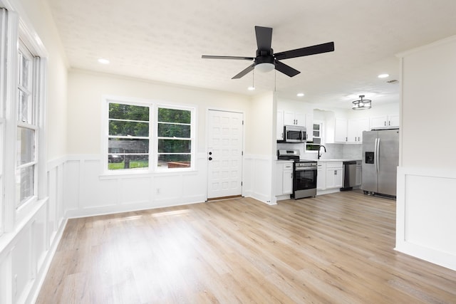2917 Doyle Ave, Columbus, GA 31907 - kitchen with stainless steel appliances, a ceiling fan, light countertops, white cabinets, and light wood finished floors