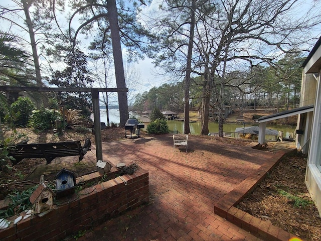 exterior space featuring a water view and a grill