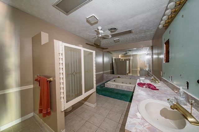 bathroom with ceiling fan, tile patterned floors, tiled bath, a textured ceiling, and vanity