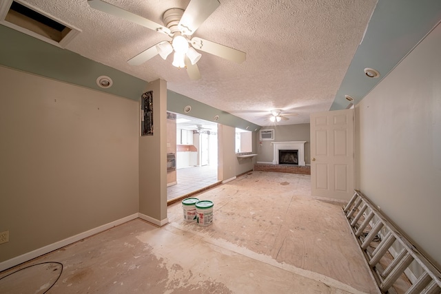 unfurnished living room with a textured ceiling and ceiling fan