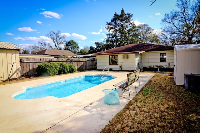 view of pool with a storage unit and a patio area