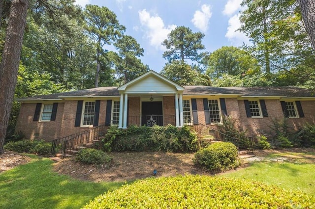 ranch-style home with brick siding and a front yard