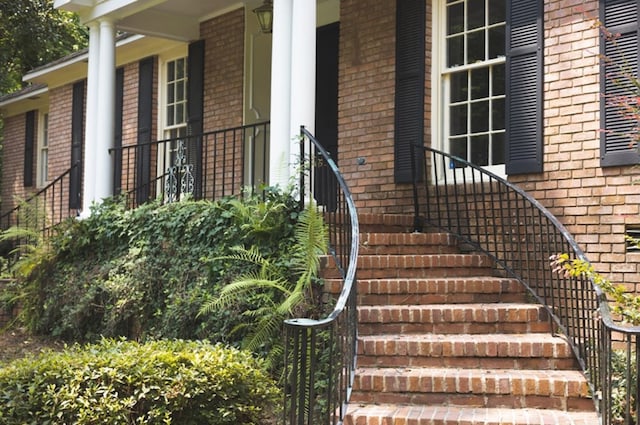 entrance to property featuring brick siding