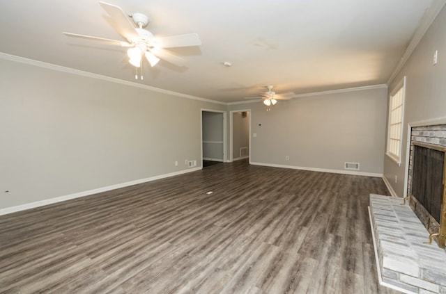 unfurnished living room with wood finished floors, a ceiling fan, baseboards, crown molding, and a brick fireplace