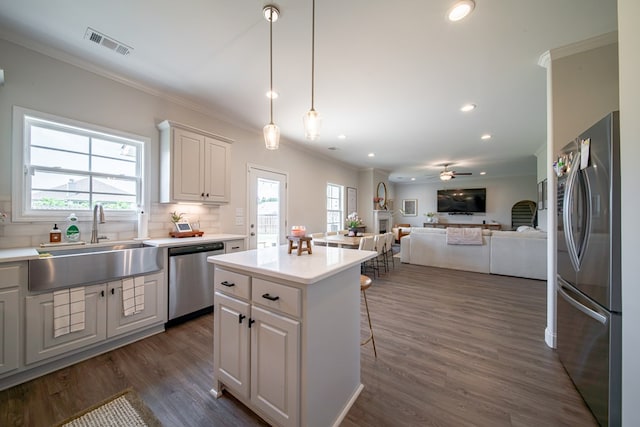 8008 Barton Dr, Midland, GA 31820 - kitchen with stainless steel appliances, crown molding, open floor plan, healthy amount of natural light, and a kitchen breakfast bar