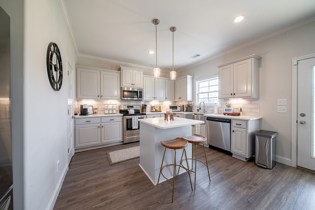 8008 Barton Dr, Midland, GA 31820 - kitchen with stainless steel appliances, dark wood-style flooring, decorative backsplash, ornamental molding, and recessed lighting