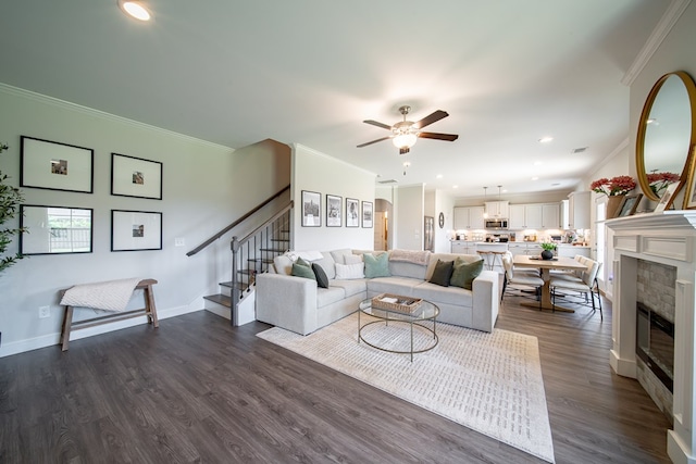 8008 Barton Dr, Midland, GA 31820 - living area with crown molding, stairs, ceiling fan, dark wood finished floors, and a glass covered fireplace