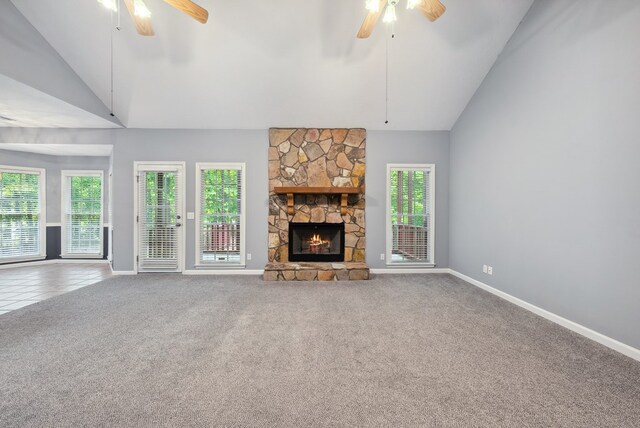 unfurnished living room featuring a ceiling fan, vaulted ceiling, carpet floors, and baseboards