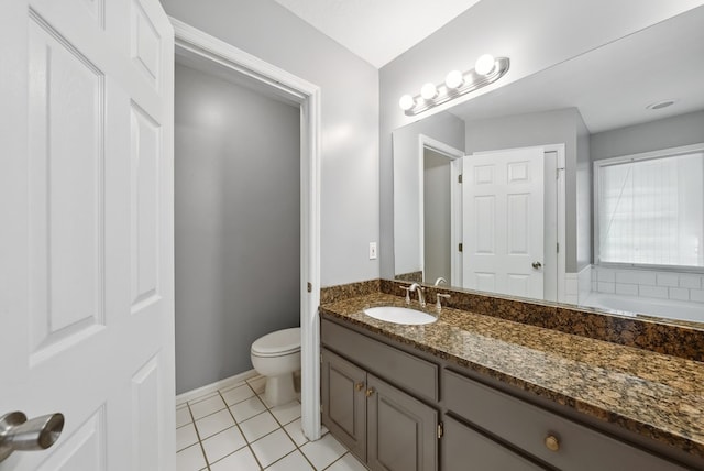 bathroom featuring tile patterned floors, vanity, toilet, and baseboards